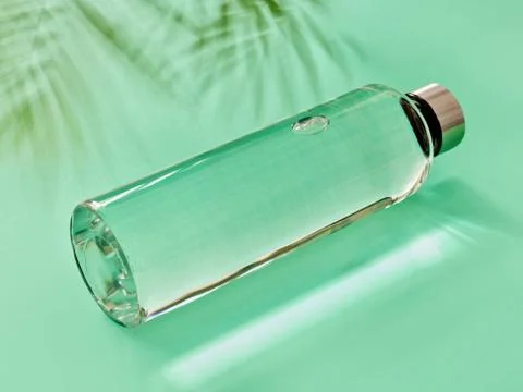 Refillable drinking water bottle on mint green background Stock Photos