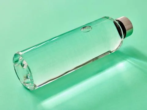 Refillable drinking water bottle on mint green background Stock Photos