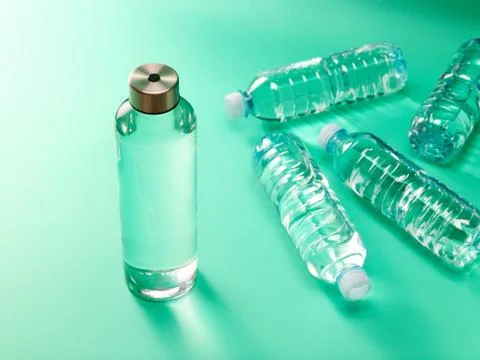 Refillable drinking water bottle on mint green background Stock Photos