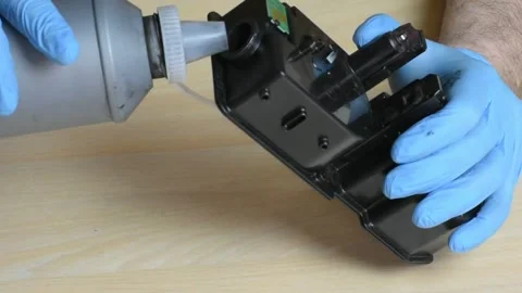 Refilling Printer Cartridge with Precision Using Toner Bottle Gloves Stock-Footage 319817220