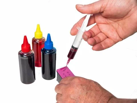 Refilling Printer Ink Cartridges With Generic Pigment Ink on a white backgrou 写真素材
