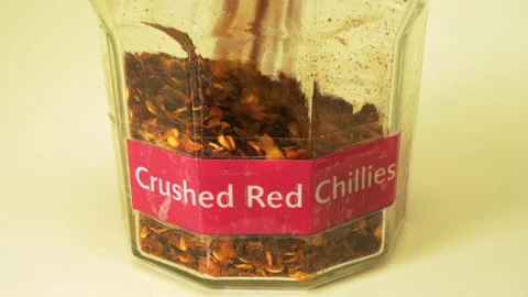 Refilling a storage jar with crushed red chillies. Stock-Footage 156400226