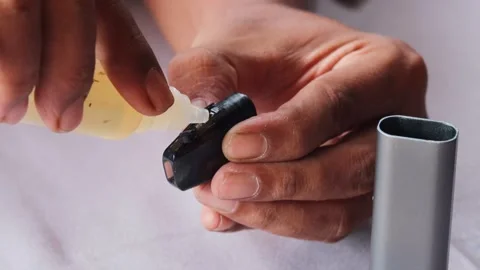 Refilling vape pod with e liquid Stock Footage 340596724