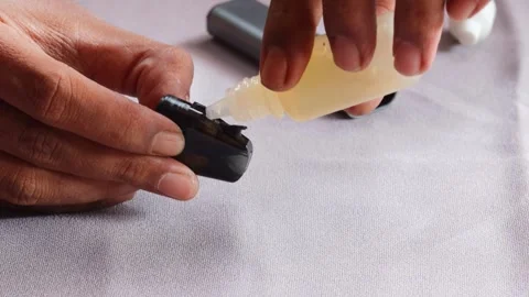 Refilling vape pod with e liquid Stock Footage 340596809