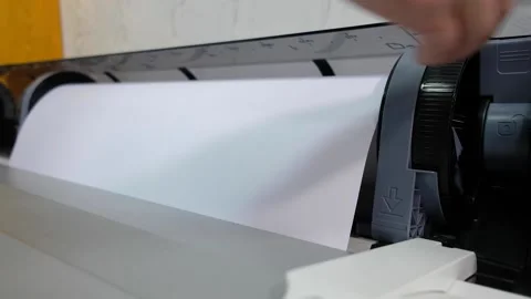 Refills a roll of white paper into the printer. printing in a printing house. pr Stock Footage 130345462
