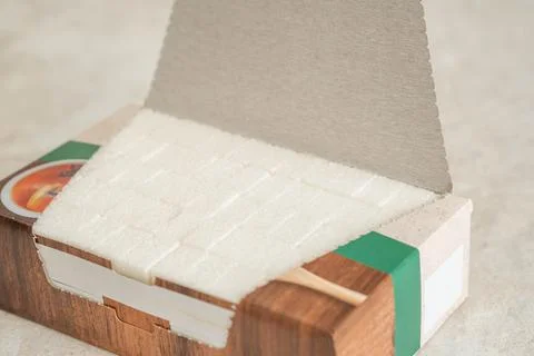 Refined cane sugar in a box cubes Stock Photos
