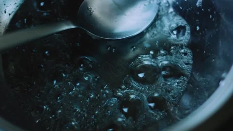 Refined cooking study of heating a small saucepan over a blue flame Stock Footage 342153969