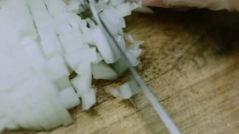 Refined macro composition of small onion cubes gathered for mixing Stock Photos