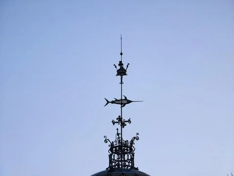 Refined metallic weather vane featuring detailed craftsmanship and modern d.. Stock Photos