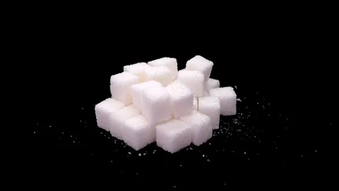 Refined sugar cubes close up rotate on a black background Stock Footage 128206787