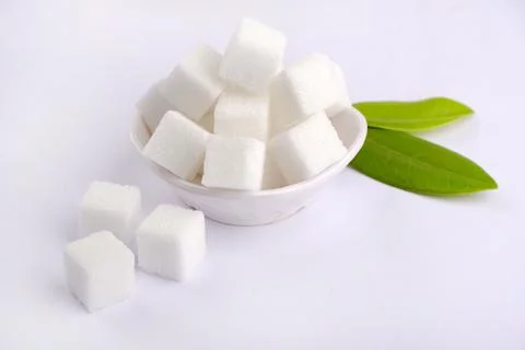 Refined sugar cubes on white background. Stock Photos