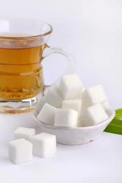 Refined sugar cubes on white background. Stock Photos