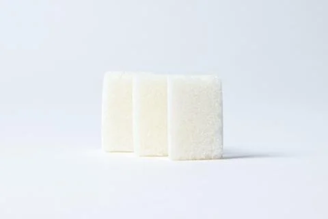 Refined sugar on a white background. Stock Photos