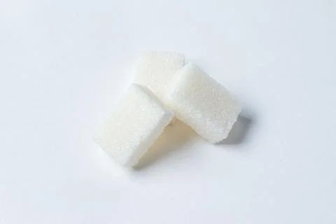 Refined sugar on a white background. Stock Photos