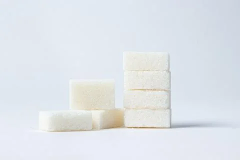 Refined sugar on a white background. Stock Photos
