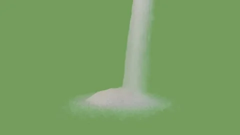 Refined white sugar falling down and forming a heap on the green screen Video stock 293689715