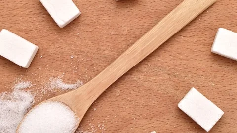 Refined white sugar, sugar cubes and wooden spoon Stock Footage 290919951