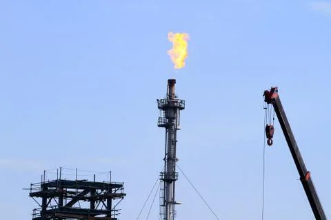 The refinery flare with cloud in background Stock Photos