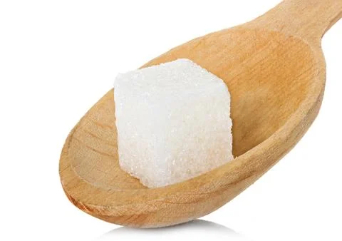 Refining sugar cube in spoon Stock Photos