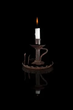 Reflected candle on black background Stock Photos