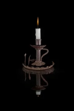 Reflected candle on black background Stock Photos