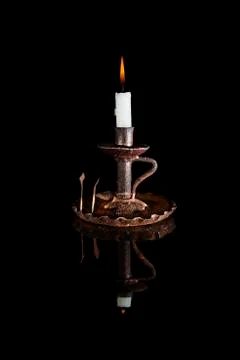 Reflected candle on black background Stock Photos