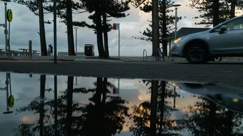 A reflected car passes Manly promenade in Sydney 6K Stock Footage 307461193