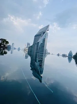 Reflected in a city infinity pool a stylish building on the horizon Fotos de archivo