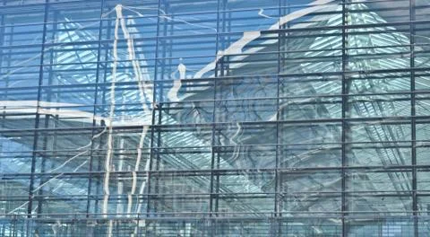 Reflected in the glass facade of the building Stock Photos