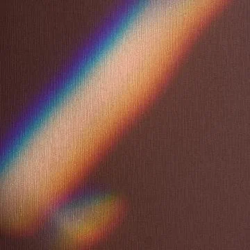 Reflected iridescent rainbow light on the wall in the apartment Stock Photos