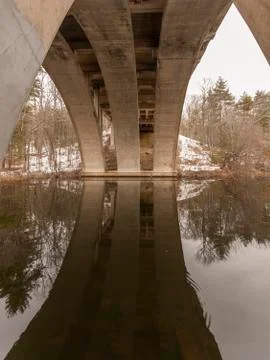 Reflected light illuminating bridge arch Stock Photos