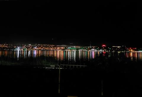 Reflected lights on a lake at night Stock Photos