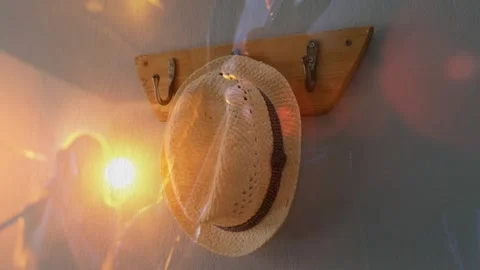 Reflected person holding device in hallway, causing warm lens flare across straw Stock Footage 334178572