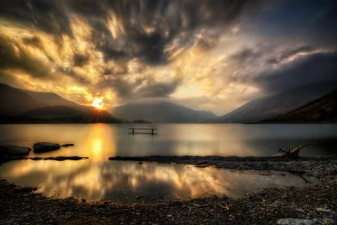 Reflected sunset on an alpine lake Stock Photos