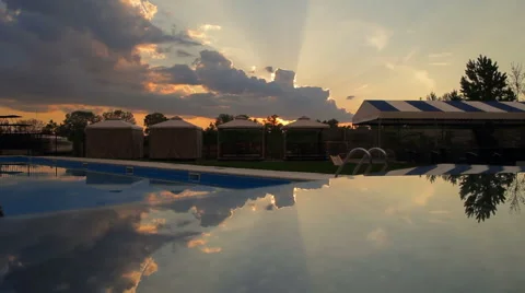 Reflected sunset and clouds over the swimming pool timelapse Stock Footage 65202022