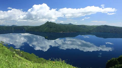 Reflecting Clouds: Lake Mashu and Mount Mashu Video stock 332321229