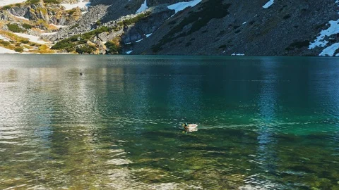 Reflecting emerald turquoise crystal clear water of mountains lake Stock Footage 121903878