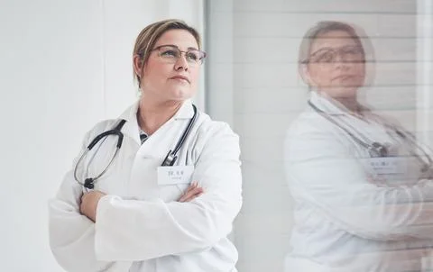 Reflecting on her days in medical school...an attractive young female doctor Stock Photos