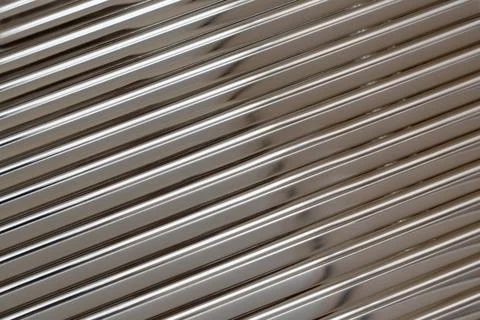 Reflecting metallic diagonal stripes creating abstract pattern 스톡 사진