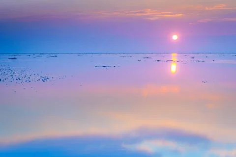 Reflecting mudflats all twilight with setting sun Stock Photos