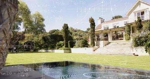 Reflecting rectangular pool showing ripples on manicured lawn in sunlit Stock Photos