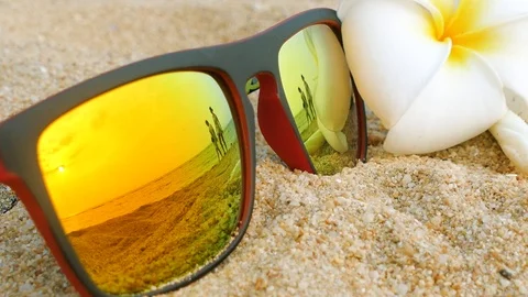 Reflecting sunglasses on a sandy beach in the summer Stock Footage 102594798