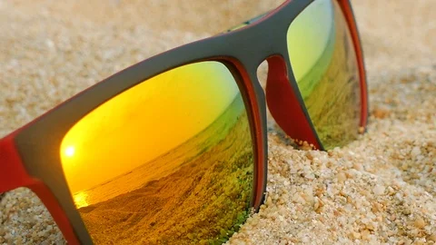 Reflecting sunglasses on a sandy beach in the summer Stock Footage 102594890