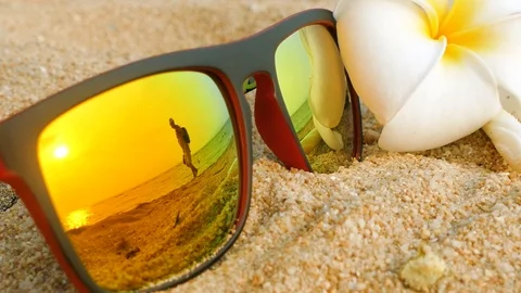 Reflecting sunglasses on a sandy beach in the summer Stock Footage 102594998