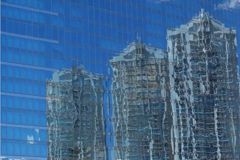 Reflection of 3 High-rises Reflected in Blue Glass 库存照片