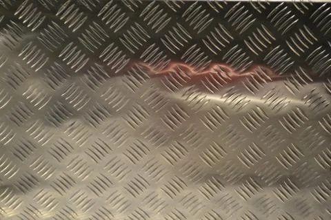 Reflection in aluminium sheet of two beautiful studded purses. Foto stock