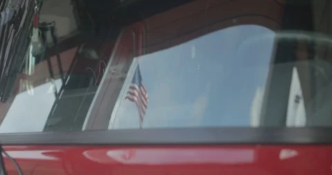 Reflection of American flag in firetruck windshield 스톡 동영상 101445015