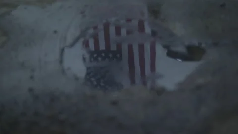 Reflection of the American Flag in a Puddle of Water Stock Footage 211869813