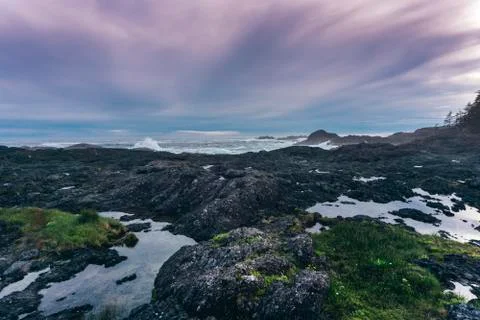 Reflection and rocks on the edge of the ocean Stock Photos