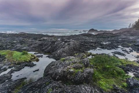 Reflection and rocks on the edge of the ocean Stock Photos